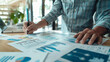 © Suriyo - Businessman reviewing performance indicators with a focus on investment data growth projections