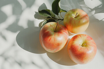 close up top view aerial shot of red gala apples on a white dinner table with the sunlight gleaming from the side window casting a shadow generative ai