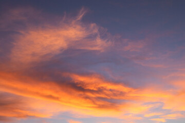 Sunset sky with orange clouds. View of orange clouds in the sky background. orange clouds illuminated by the setting sun