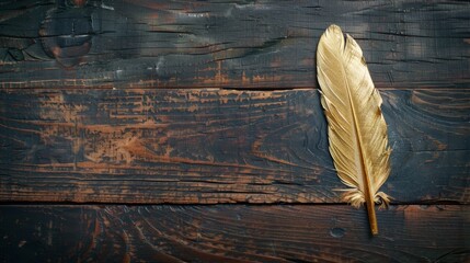 Gold feather on dark wooden table.