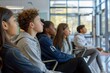 © spyrakot - Diverse Group of Students Attentively Listening in Bright Modern Classroom