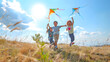 © domi002 - Children joyfully run, coordinating efforts to fly a colorful kite high into the sky.