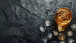 © Oleksiy - Cold whiskey in a glass with crushed ice on a black stone wet background, top view