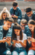 © Christoph Burgstedt - Group of young people who are preoccupied with their smart phones, which are an important part of culture and can lead to addiction