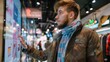 © dheograft - Client using touch screen board in trendy clothing store, shopping for fashion collection items in shop. Young buyer buying clothes on interactive monitor, self ordering concept