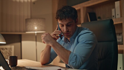 Wall Mural - Busy worker calling cellphone working at dark workplace agency close up. 