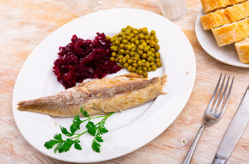 Sticker - Fillet appetizing cold smoked mackerel with canned peas and grated boiled beets. Decorated with a sprig of parsley