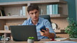 © stockbusters - Business worker celebrating message in office. Happy man receiving good news