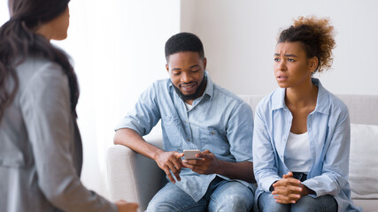 Frustrated Afro Woman Complaining Marital Counselor About Husband Indifference In Office. Selective Focus