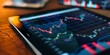 © kwanchaift - Detailed stock market chart on a digital tablet with financial news and market updates, symbolizing global finance and economic trends