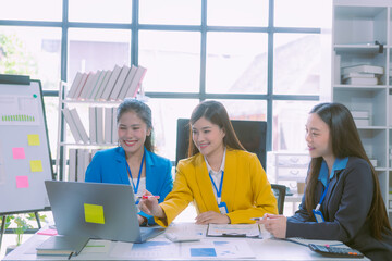 Successful Asian businesswoman presenting team meeting minutes and presenting ideas in the office