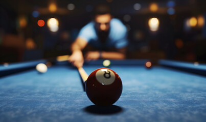 Wall Mural - A close-up of the 8-ball on a pool table, with a blurred background of a player taking a shot.