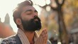 © The Little Hut - Portrait of bearded religion indian man praying with closed eyes to God asking for blessing help forgiveness outdoor Adult guy clasping hands wishing luck in urban sunny city street To : Generative AI