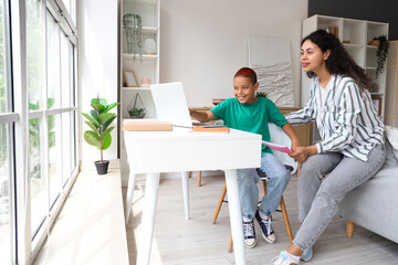 Sticker - Little African-American boy with his mother doing lessons at home