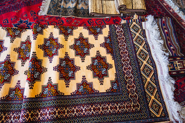 Wall Mural - Modern luxurious colorful handmade Arab carpets on the oriental market in Uzbekistan close-up