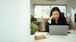 © Prathankarnpap - Portrait of charming young businesswoman working on laptop in home office