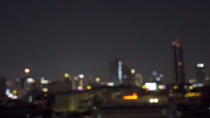 Poster - Bokeh abstract background of skyscraper buildings in Bangkok city, Thailand with lights, Blurry photo at night time. Cityscape.