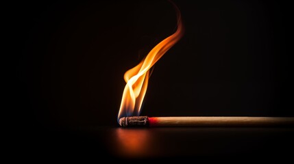 Burning match on a dark background.