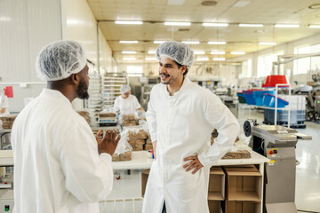 Poster - Food factory manager explaining to his new employee food making process at food factory