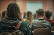 © antusher - Audience of students or workers listening to a conference in meeting room
