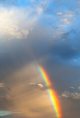 Wall Mural - beautiful sky landscape with colorful rainbow on blue sky with clouds after rain at sunset in summer