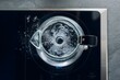 © Littledog - Boiling Water in Glass Kettle: Close-up view of a glass kettle with water boiling on a modern black electric stove top. The water bubbles and swirls, creating a hypnotic visual of the heating process.