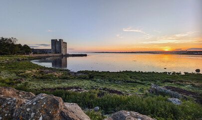 Beautiful coastal sunset scenery with historical landmark Oranmore castle at Galway bay, Ireland, Wild Atlantic way, buildings and architecture background, wallpaper