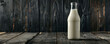 © AI_images_for_people - Fresh milk in a transparent bottle against a black wooden background, highlighting the creamy texture of the milk against the dark wood.