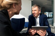 © Westend61 - Smiling businessman holding tablet PC and discussing strategies with colleague