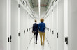 © Westend61 - Young engineers walking in server room at data center