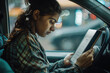 © PRASANNAPIX - young indian woman using smartphone in the car