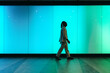© VISTA by Westend61 - Businessman walking across blue glowing wall