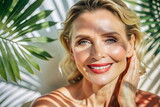Beautiful smiling mature woman lady with makeup close up portrait on leaves background. Healthy face skin care beauty, middle age skincare cosmetics, cosmetology concept