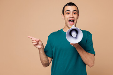 Sticker - Young surprised middle eastern man wear blue t-shirt casual clothes hold in hand megaphone scream announces discounts sale Hurry up isolated on plain pastel beige background studio. Lifestyle concept.