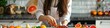 © Артур Комис - close-up of a woman cutting fruit in the kitchen. Selective focus