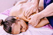 © grigvovan - Masseur massages back muscles of young woman in spa salon.