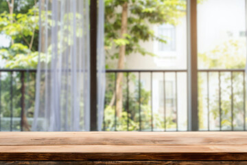 Aufkleber - Empty wooden table with a blurred balcony view of a green garden background