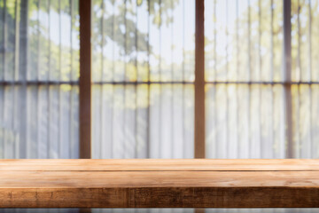 Poster - Empty wooden tabletop over blurred window background for product montage