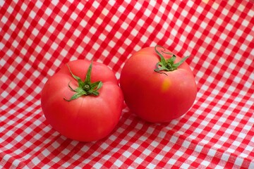 Wall Mural - Fresh tomatoes on the red cloth