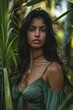 © Hanna - A woman with long dark hair is wearing a green dress and standing in a jungle