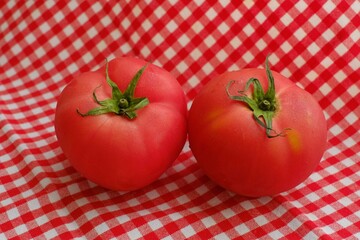 Wall Mural - Fresh tomatoes on the red cloth