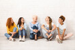 © Prostock-studio - Girls Power. Diverse Women Sitting On Floor Talking Smiling Each Other Indoor. Selective Focus