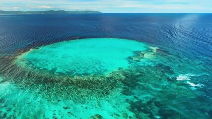 Sticker - The turquoise waters of a tropical atoll are a stark contrast to the deep blue of the surrounding ocean creating a mesmerizing sight from above.