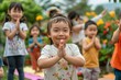 © Milos - A group of young children practicing yoga together outside in a lush garden, with one child smiling and showing a namaste pose, emphasizing mindfulness and unity.