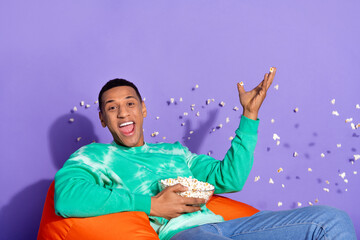 Wall Mural - Photo of excited good mood guy wear teal sweatshirt watch fillm throw pop corn isolated purple color background