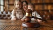 © kodidesign - Wooden Judge's Gavel Family in Background, Suitable for Legal and Family Law Themes