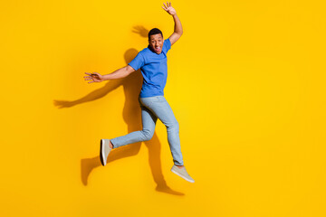 Sticker - Full size photo of pretty young male jump running wear trendy striped outfit isolated on yellow color background