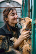 © john - Dog at the shelter. Animal shelter volunteer takes care of dogs.