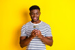 © deagreez - Portrait of nice young man use smart phone wear striped t-shirt isolated on vibrant yellow color background