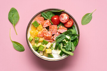 Wall Mural - Salmon bowl with spinach, rice, avocado, tomato, cucumbers on pink background, top view. Poke bowl, healthy eating